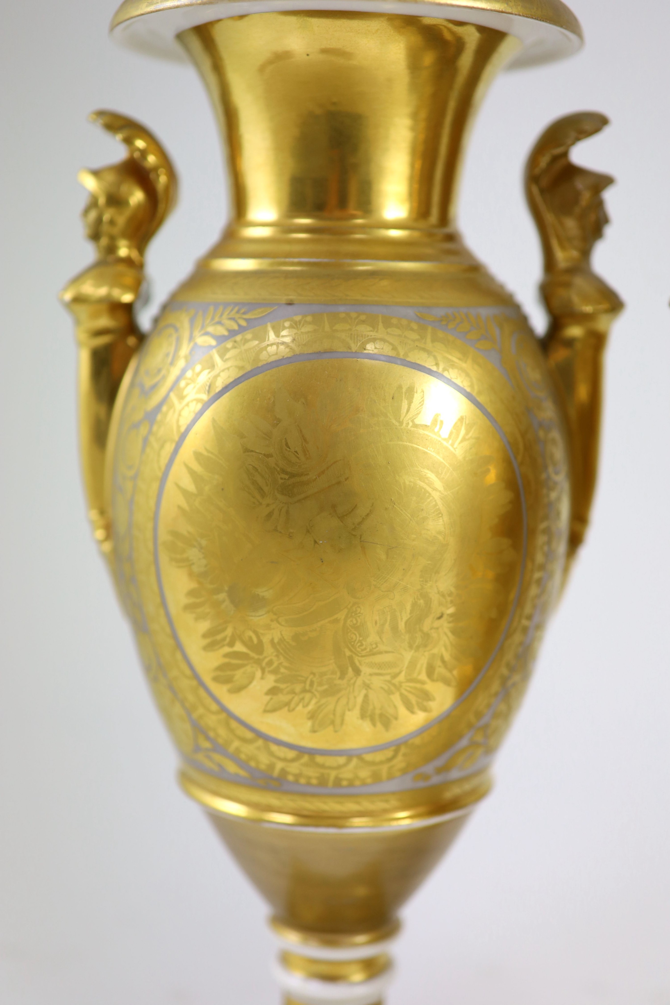 A pair of Paris porcelain vases, early 19th century, 33.5 cm high, one base restored